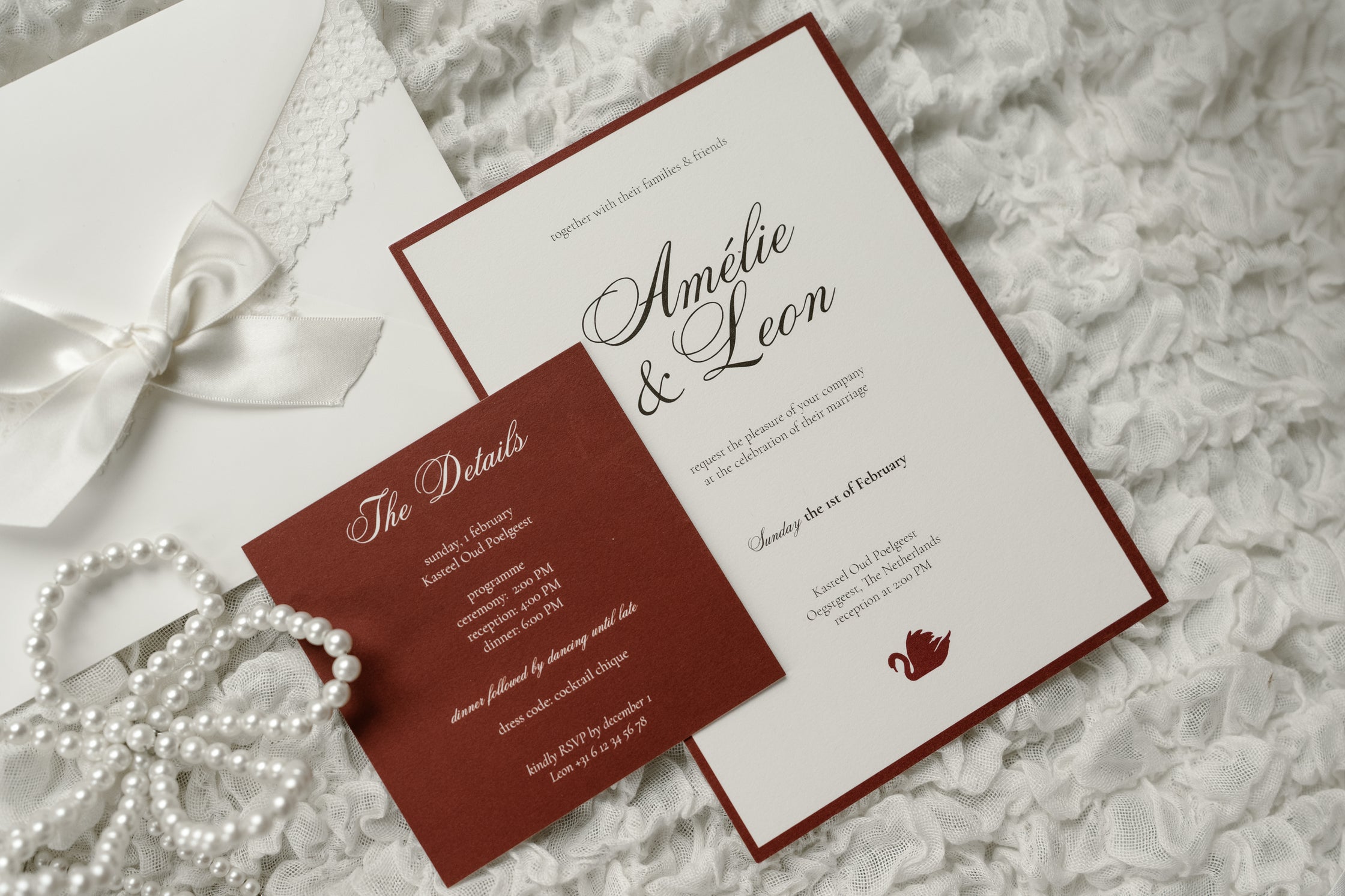 Wedding invitation card with red and white design on a textured surface