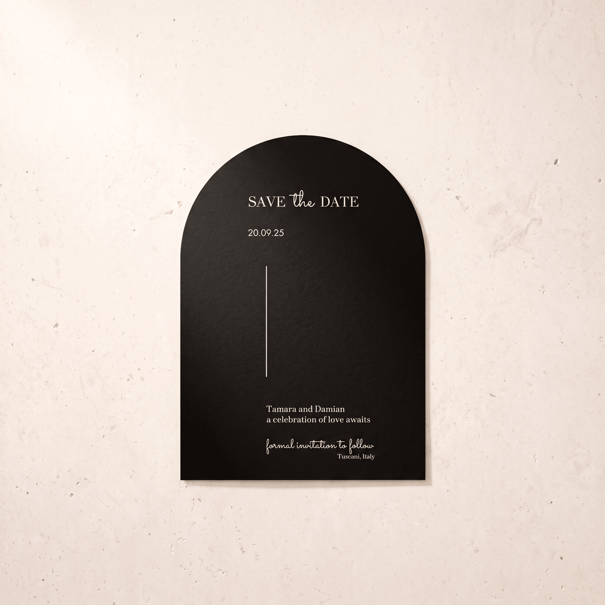 A black arched 'Save the Date' card with elegant white typography, displayed against a textured beige background.