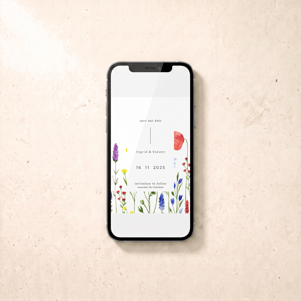 A black smartphone lying on a light beige textured surface, displaying a wedding save-the-date card design with floral illustrations and the names 'Higuchi & Steven' and the date '16 11 2025'.