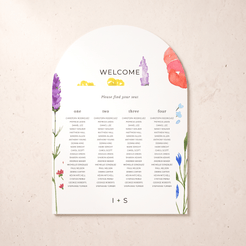 An arched wedding seating chart card with floral illustrations in purple, pink, yellow, blue, and green on a light beige textured background.