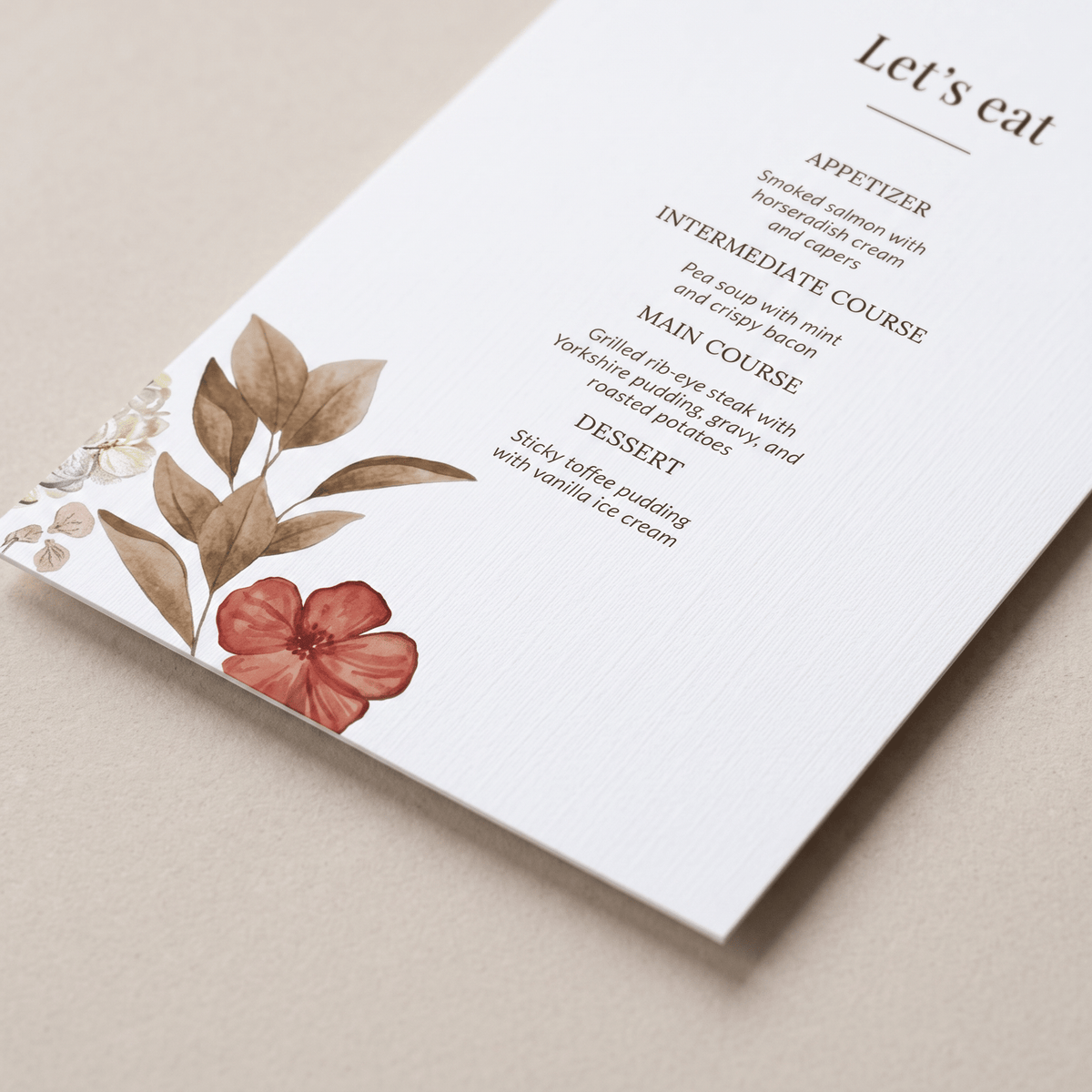 A printed menu card or invitation page with elegant typography and botanical illustrations, photographed on a neutral beige surface. The card includes course headings and a floral design with brown leaves and a pink flower.