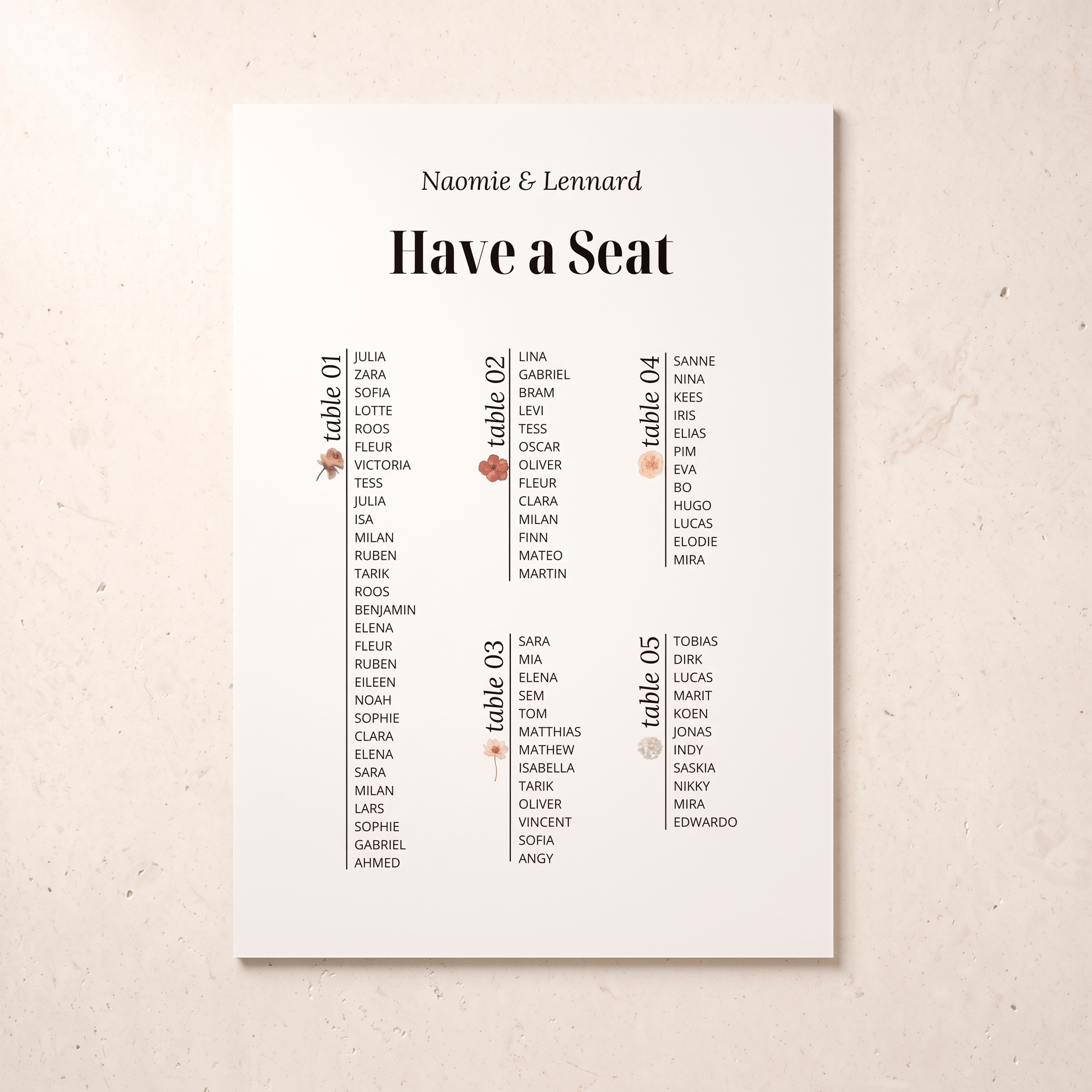 A vertical white wedding seating chart print with the names 'Naomie & Lennard' at the top and columns labeled table 01 through table 05, photographed against a light beige textured background.