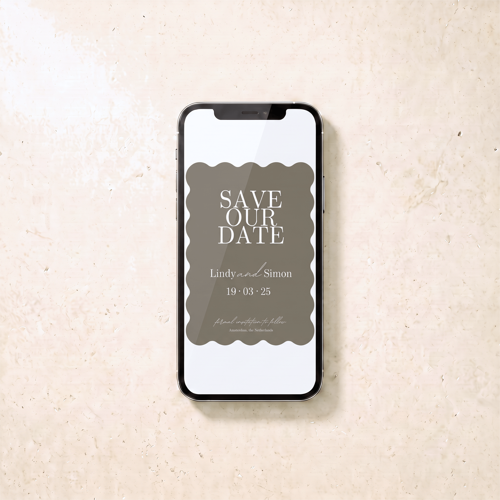 A smartphone centered on a light beige stone-like surface, displaying a 'Save Our Date' invitation card design with a muted taupe background and white text.