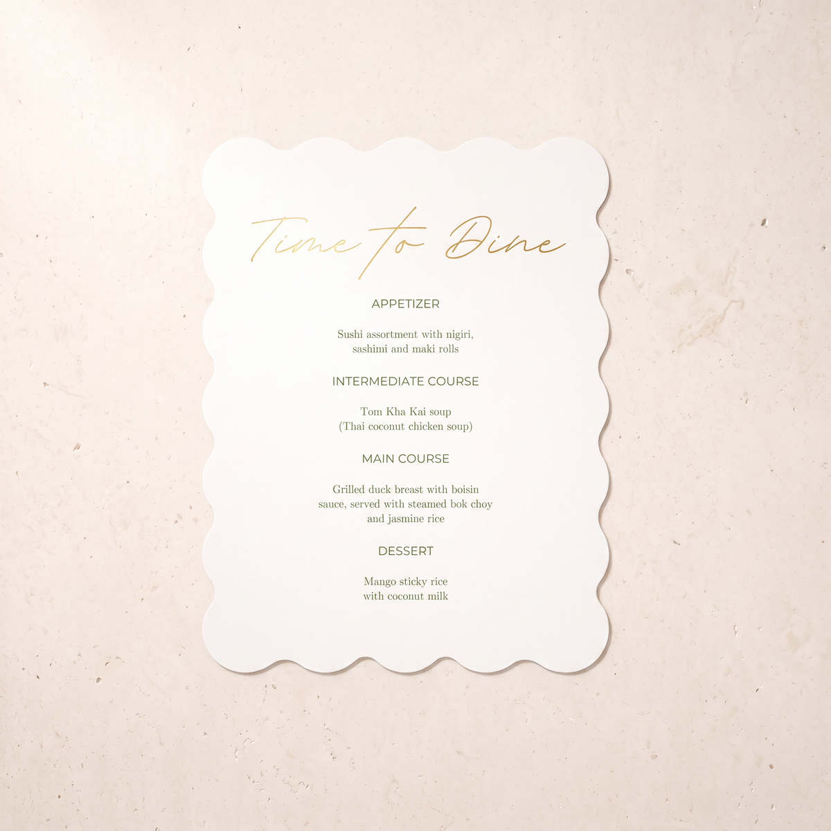 A scalloped white paper menu card with elegant gold foil text reading 'Time to Dine' and black printed meal options, placed on a light beige textured surface.