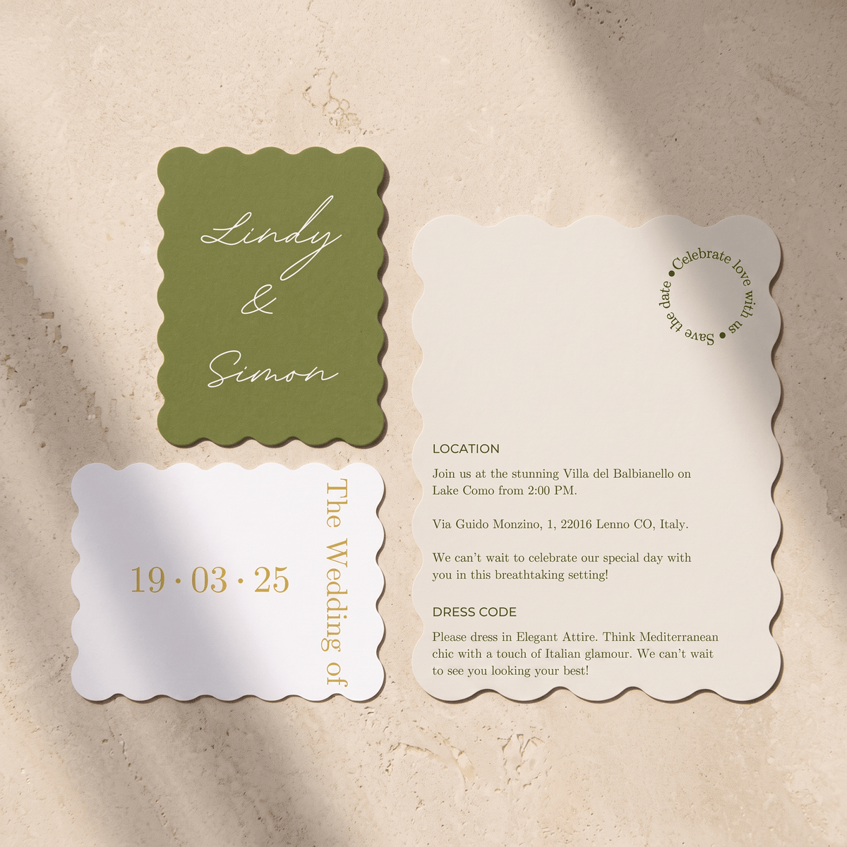 A wedding invitation suite featuring a scalloped-edge card set in olive green and cream, laid out on a textured beige background. The suite includes a green card with white script reading 'Lindy & Simon', a white card with the wedding date '19.