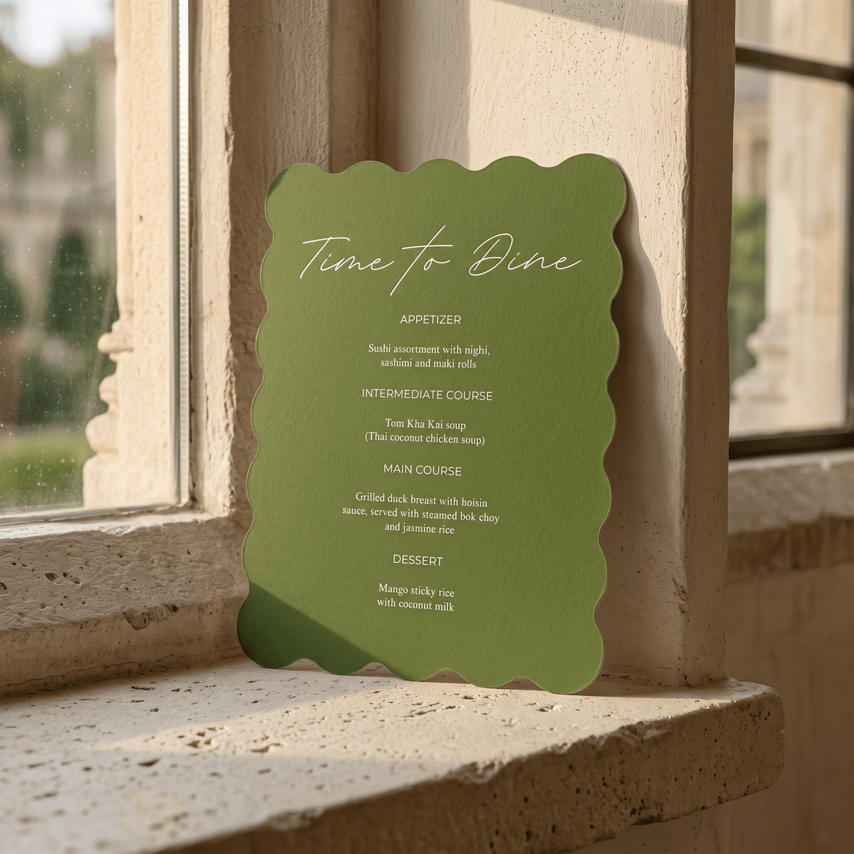 A green scalloped-edge menu card titled "Time to Dine" leaning against a stone window sill in warm natural light.