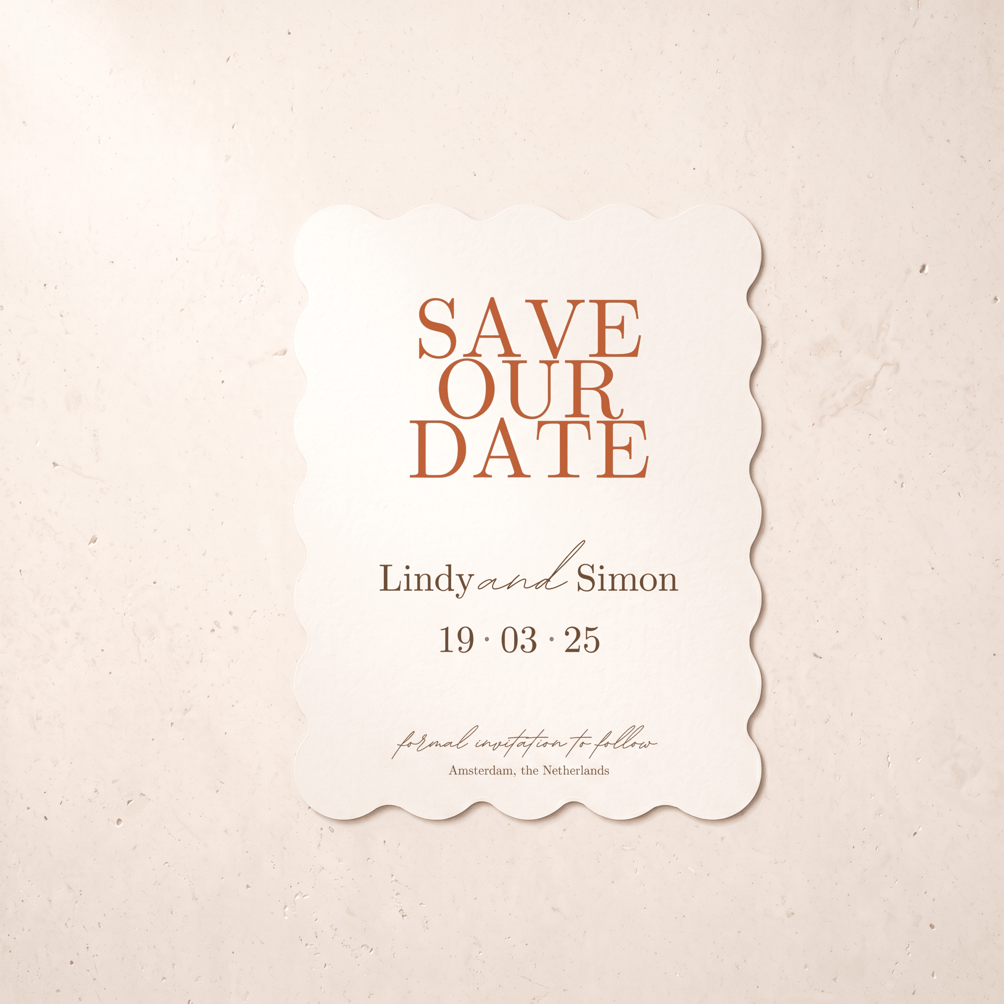 A scalloped off-white 'Save Our Date' card with terracotta and dark brown text, displayed flat against a textured beige background.