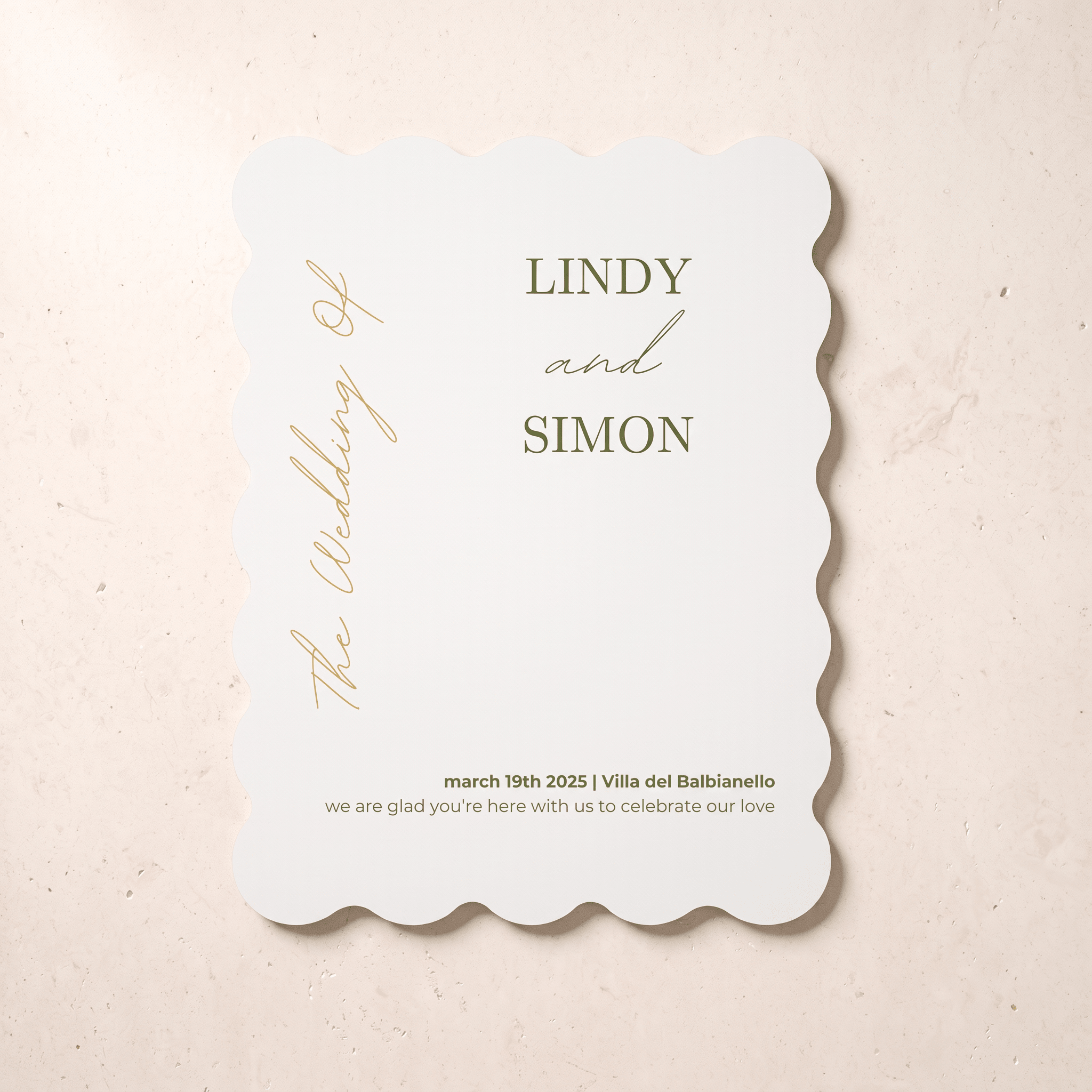A scalloped-edge white wedding invitation card with elegant gold typography, displayed flat on a light beige textured background. The card features the names 'LINDY and SIMON' and wedding details for March 19th, 2025, in Villa del Balbianello.