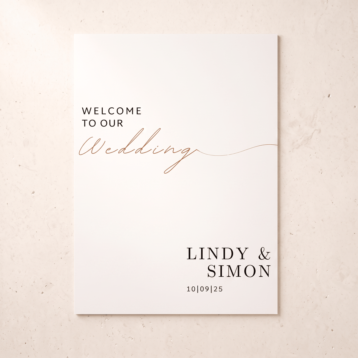 A minimalist wedding welcome card with black serif text reading 'WELCOME TO OUR' and 'LINDY & SIMON' with the date below, accented by a rose-gold script 'Wedding' across the center, shown on a light beige textured background.